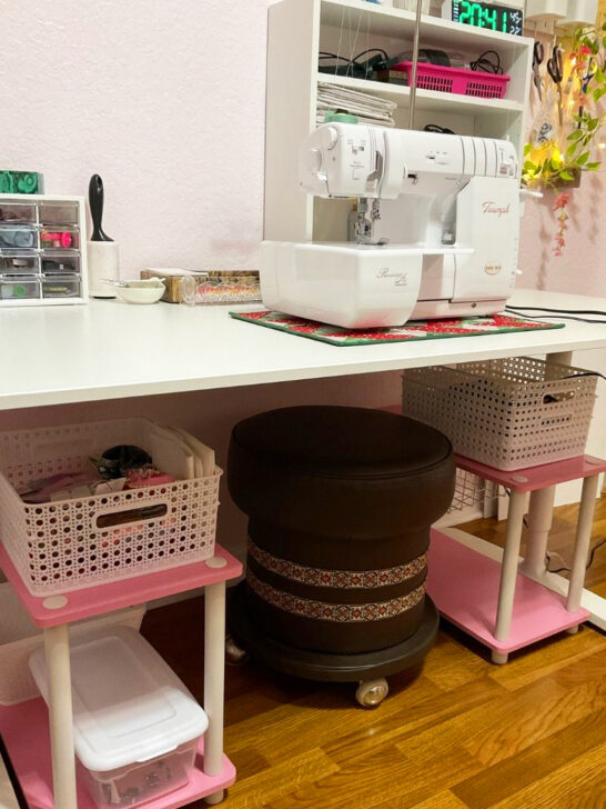 A sewing machine on a table, surrounded by charming sewing room decor