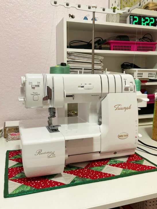 A sewing machine placed on a table, topped with a vibrant quilt decor