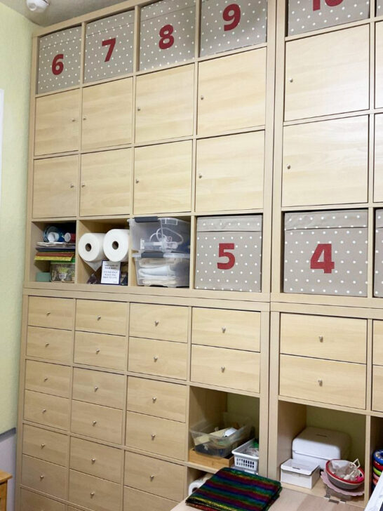 A sewing room filled with numerous drawers and boxes