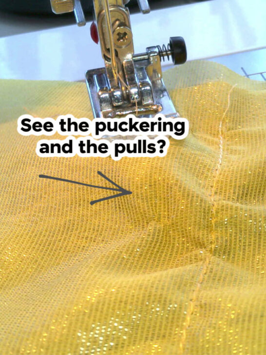 A stitch on yellow silk chiffon fabric with visible puckering and fabric damage caused by using an inappropriate needle.