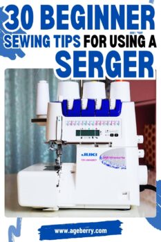 A close-up of a white Juki MO-2000QVP serger machine with blue and purple accents, set against a blurred background. The image features the title "30 Beginner Sewing Tips for Using a Serger" in bold blue and black text, with "www.ageberry.com" at the bottom on a brushstroke-style banner.