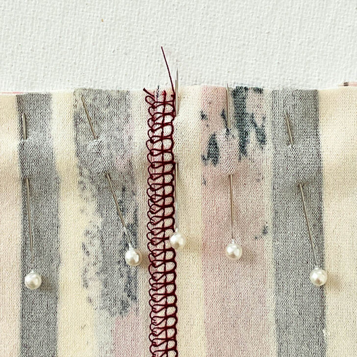This pinning step is critical to keep the fabric aligned as it stretches. Add more pins around the seam for security.