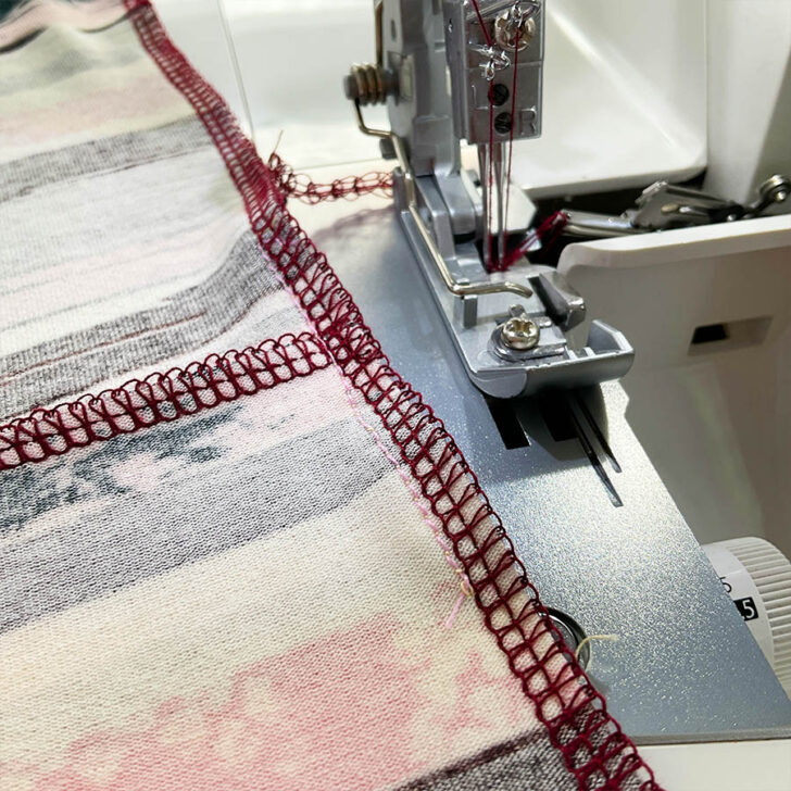 After finishing the seam with the serger. The thread tails still attached, basting stitch still visible.