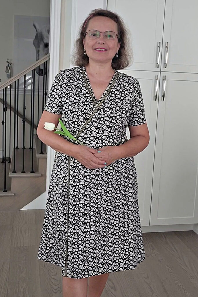 A black and white wrap dress with a floral print, featured in a fashion sewing tutorial on making and sewing your own pattern.