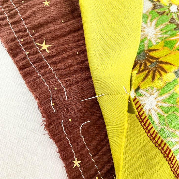 Pinning woven fabric. Align the seams and pin with precision. Insert a pin through the stitch line of one piece and into the stitch line of the other.