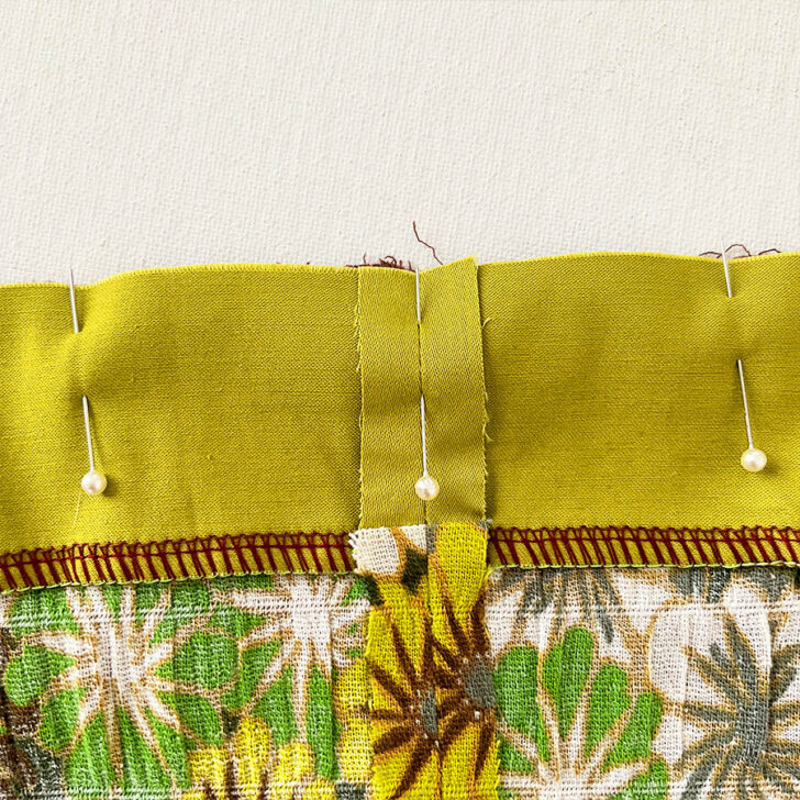 Continue pinning woven fabric. Secure the fabric with additional pins around the seam.