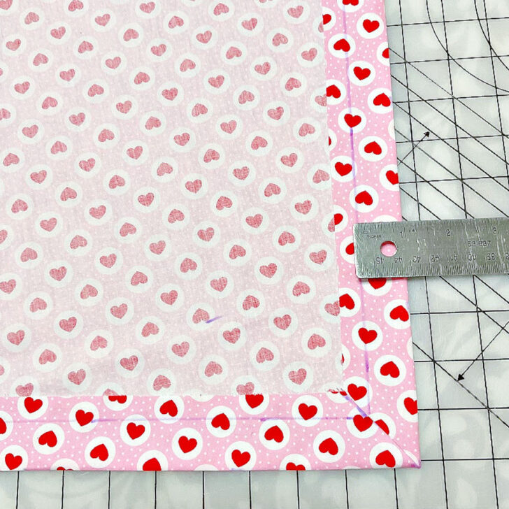 Once all the corners are turned and shaped, the edges of your quilt will begin to form clean mitered corners, ready for finishing