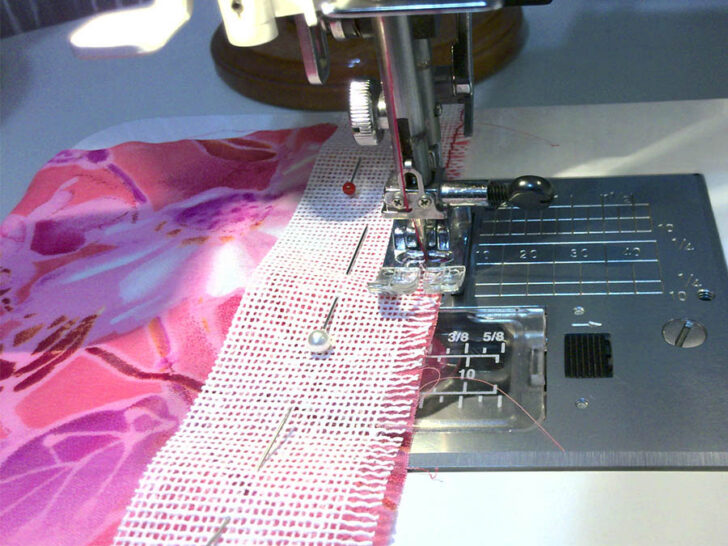 Stitch over the frayed edge along the length of the hem