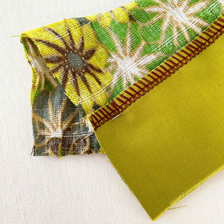 Pinning. Back of the fabric, where you can see the pin inserted precisely into the seam line.