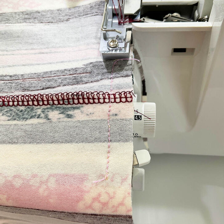 After checking, sew the final seam using a 4-thread overlock stitch on your serger. Align the serger's left needle with the straight basting stitch as a guide.