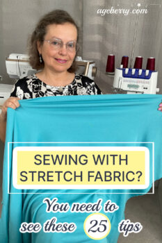 A woman holding a piece of bright turquoise stretch fabric in front of her, smiling at the camera. Behind her, a sewing machine and a serger with red thread spools are visible. The text overlay reads "Sewing with Stretch Fabric? You need to see these 25 tips," with the website "ageberry.com" at the top.