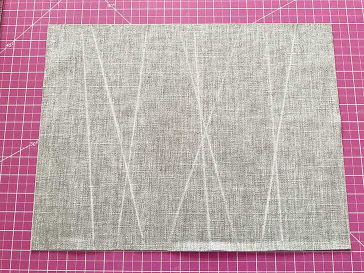 The base material for the placemat with markings for the decorative ribbons placement