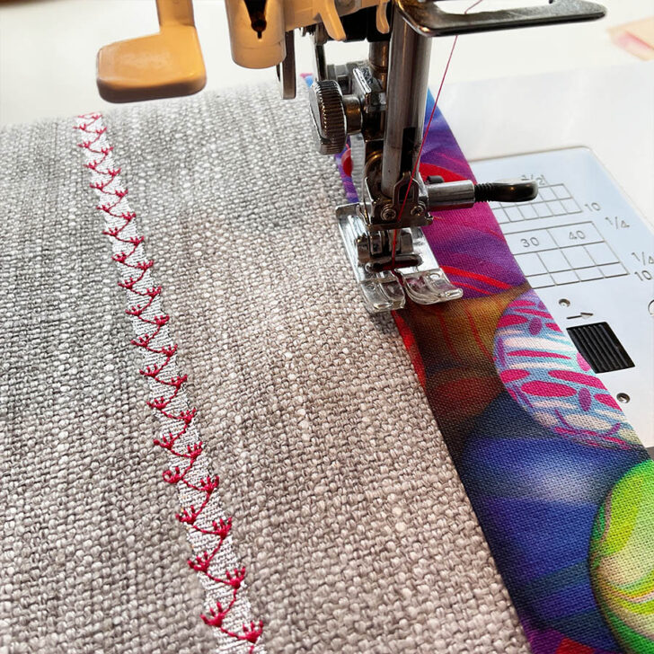 Image shows the sewing machine while sewing the final stitch fixing the placemat to the backing fabric