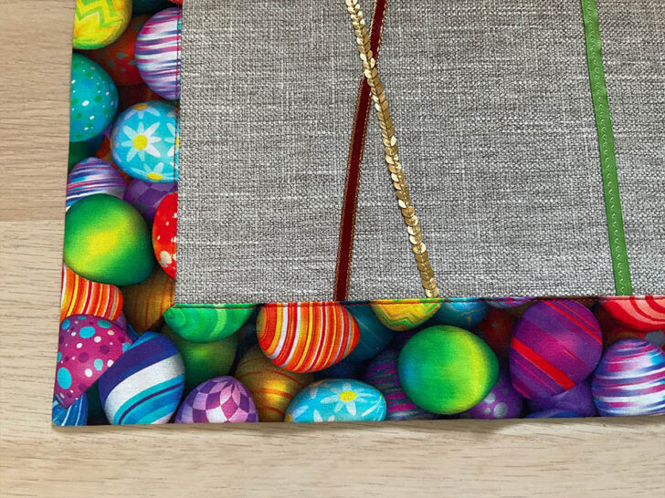 Image shows a close up of a corner of the Easter table runner after the final press