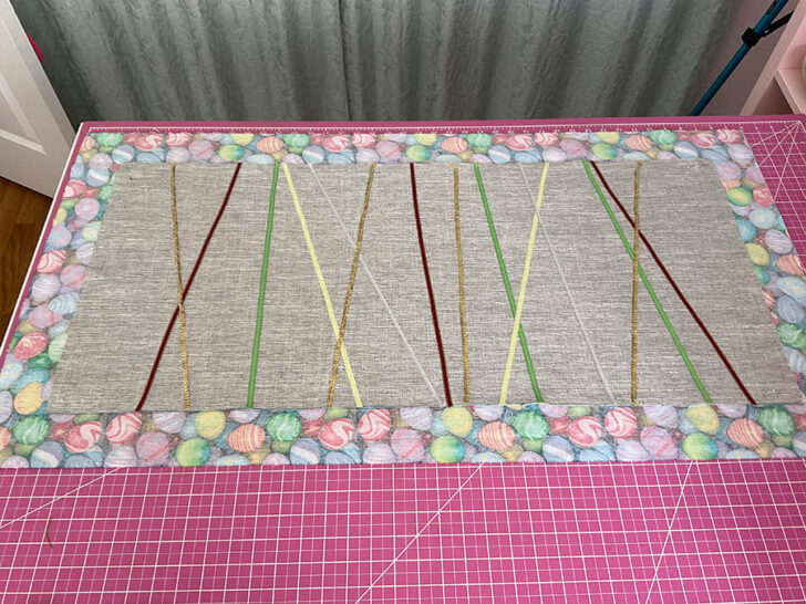 The image shows the finished product laying on top of the backing fabric before the final binding