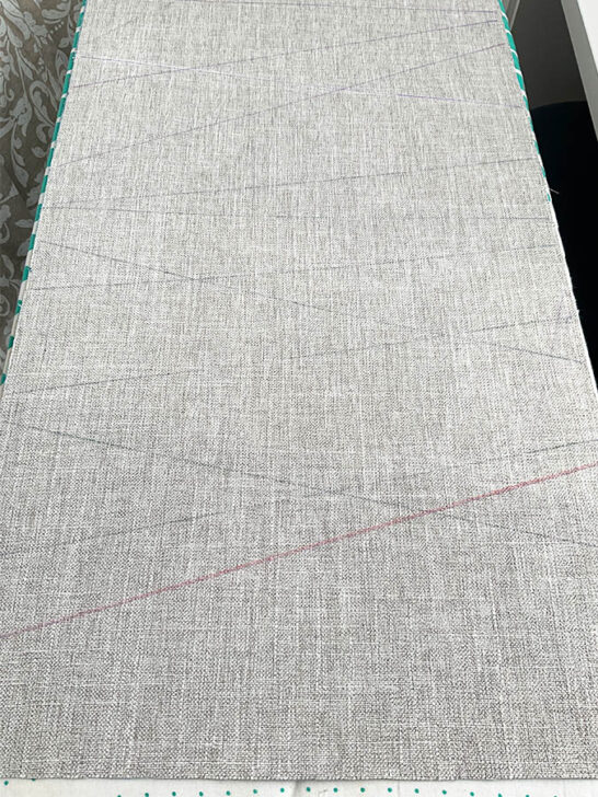 Marks made with heat erasable pen for the future positions of the decorative ribbons on the table runner