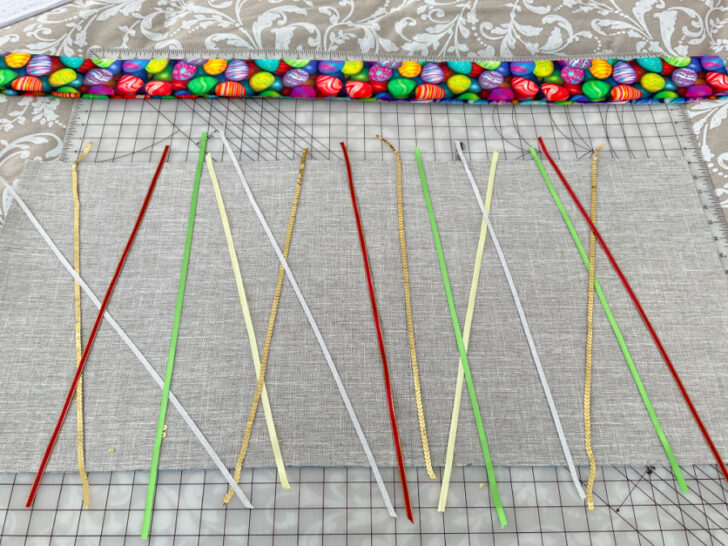 Preliminary arrangement on the base material for the decorative and sequin ribbons to determine the best positions and combination before sewing