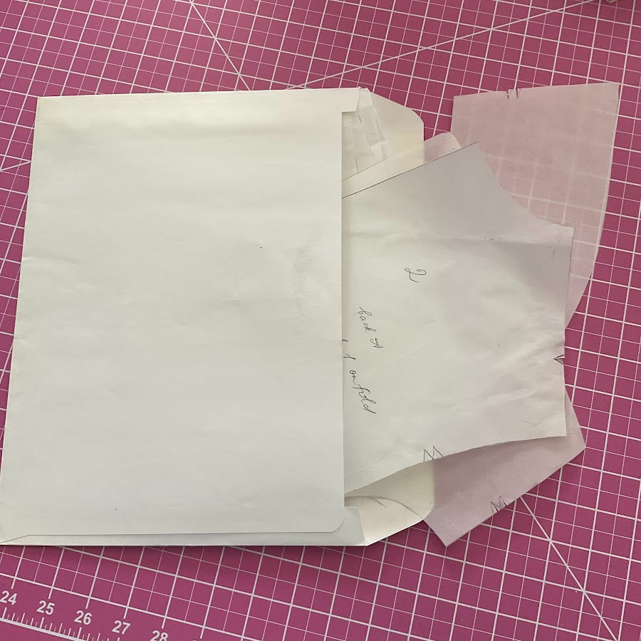 Pieces of cut patterns stored in a letter size envelope 9"x12"