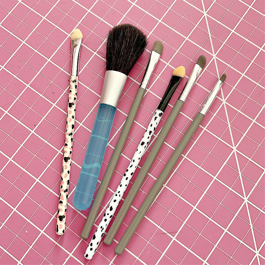 A makeup brush set on top of a cutting mat