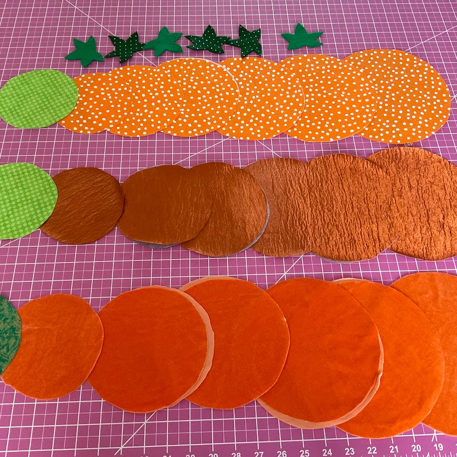 Fabric circles and stars in preparation for making fabric pumpkins from yo-yos