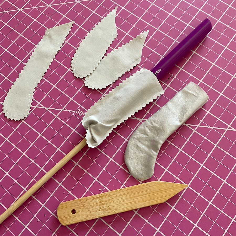 The image shows tubes sewn for a doll feet before after and while being turned right side out using a chopstick