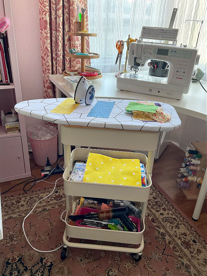 A three-tier rolling cart turned into a mobile ironing station