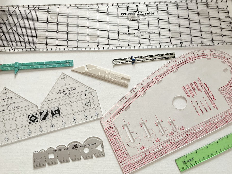 A collection of various quilting and sewing rulers arranged for display purposes