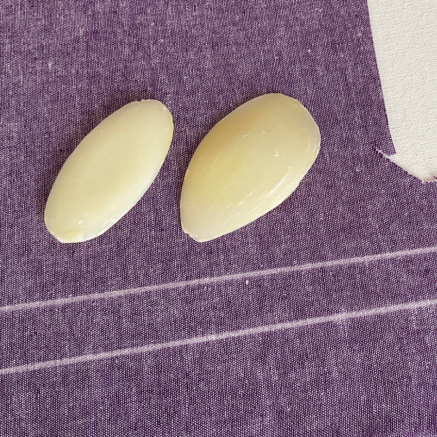 two soap slivers on a piece of denim material with two