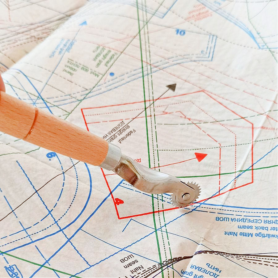 A tracing wheel on top of a paper pattern