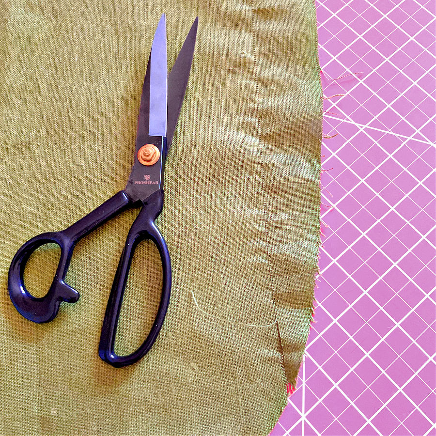 image of a pair of professional tailors shears laying on a piece of fabric