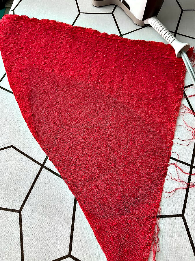 image of the shape of the hot iron left after pressing on a piece of material with a different color than the material