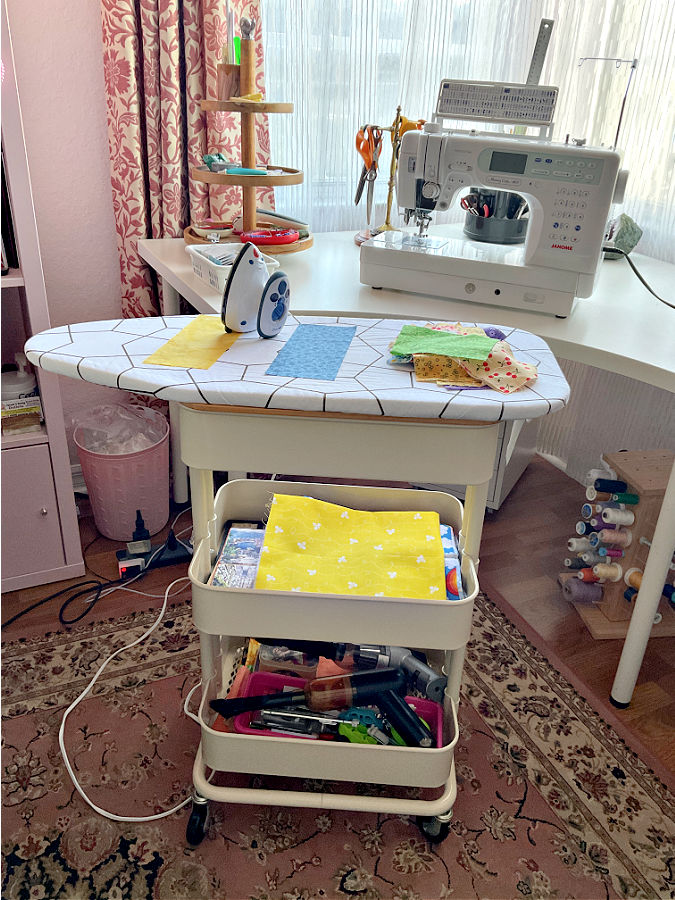 a small ironing board on an Ikea cart making a movable small ironing station