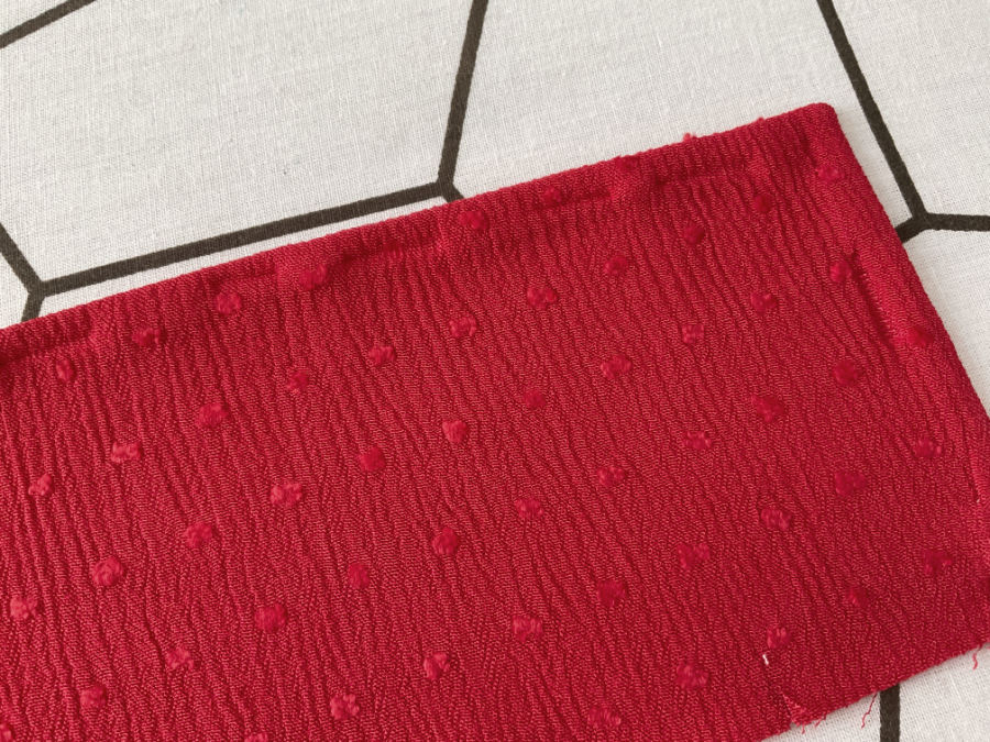 A piece of material with pin marks left after ironing over pins