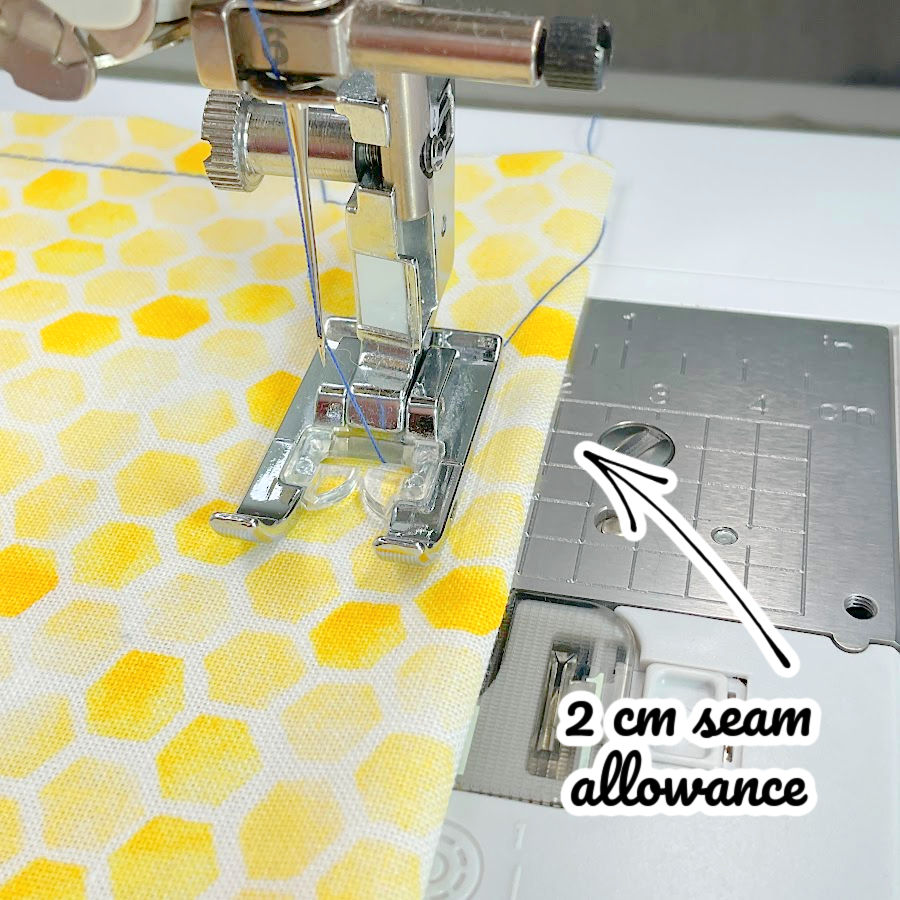 image shows how to use a measurement guide to make a 2cm seam allowance while sewing