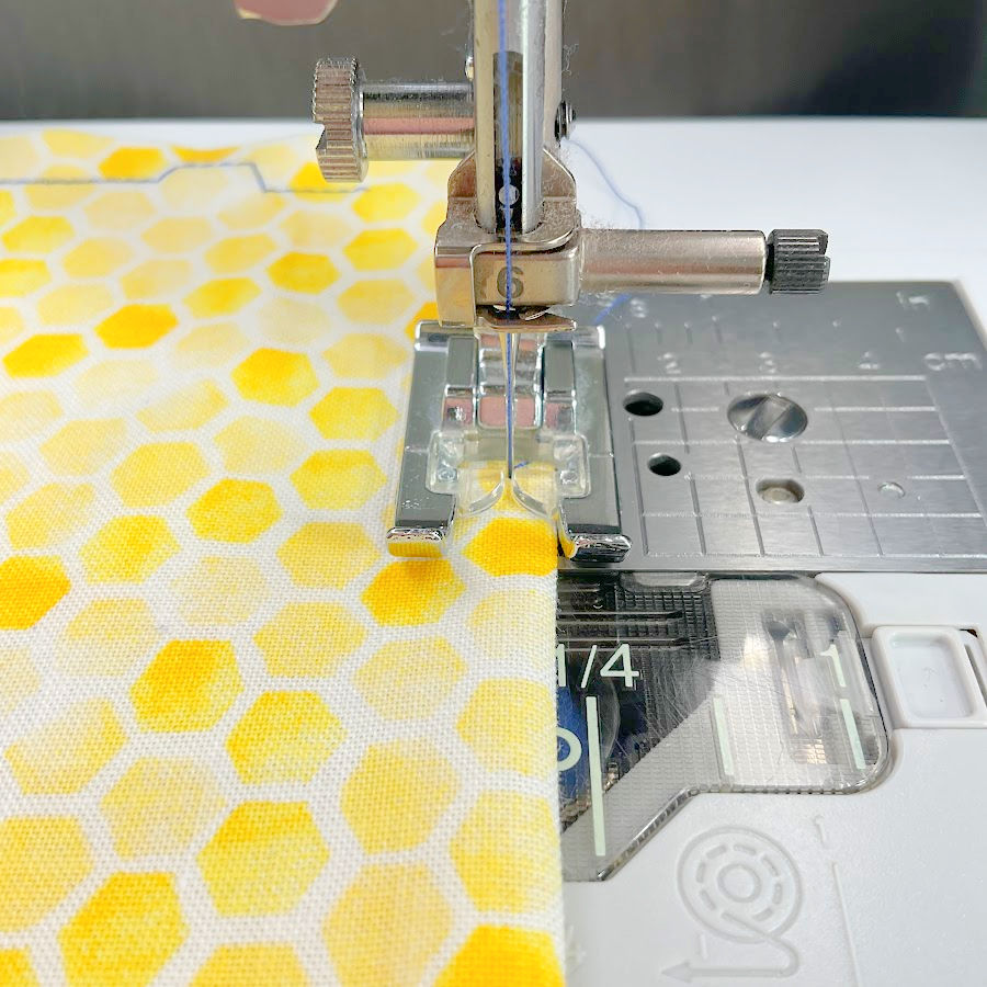 using the inner part of the presser foot as a fabric guide while sewing