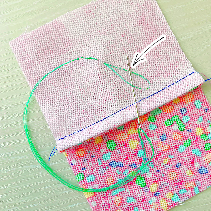 pass the needle through the loop in the thread go secure the start of the stitch