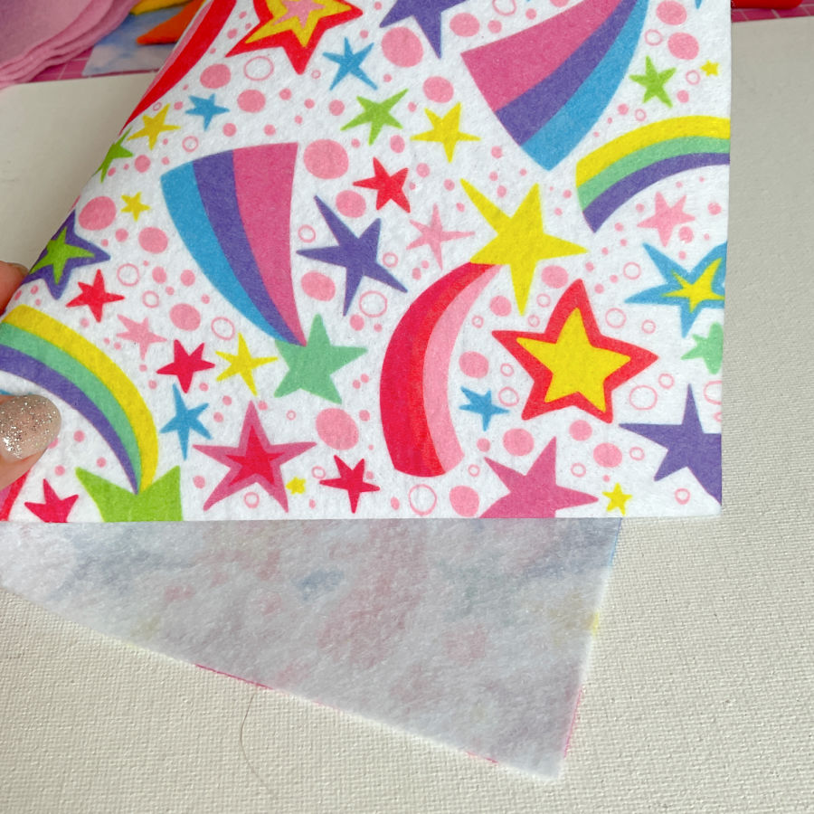 a piece of felt printed with a star and rainbow color pattern