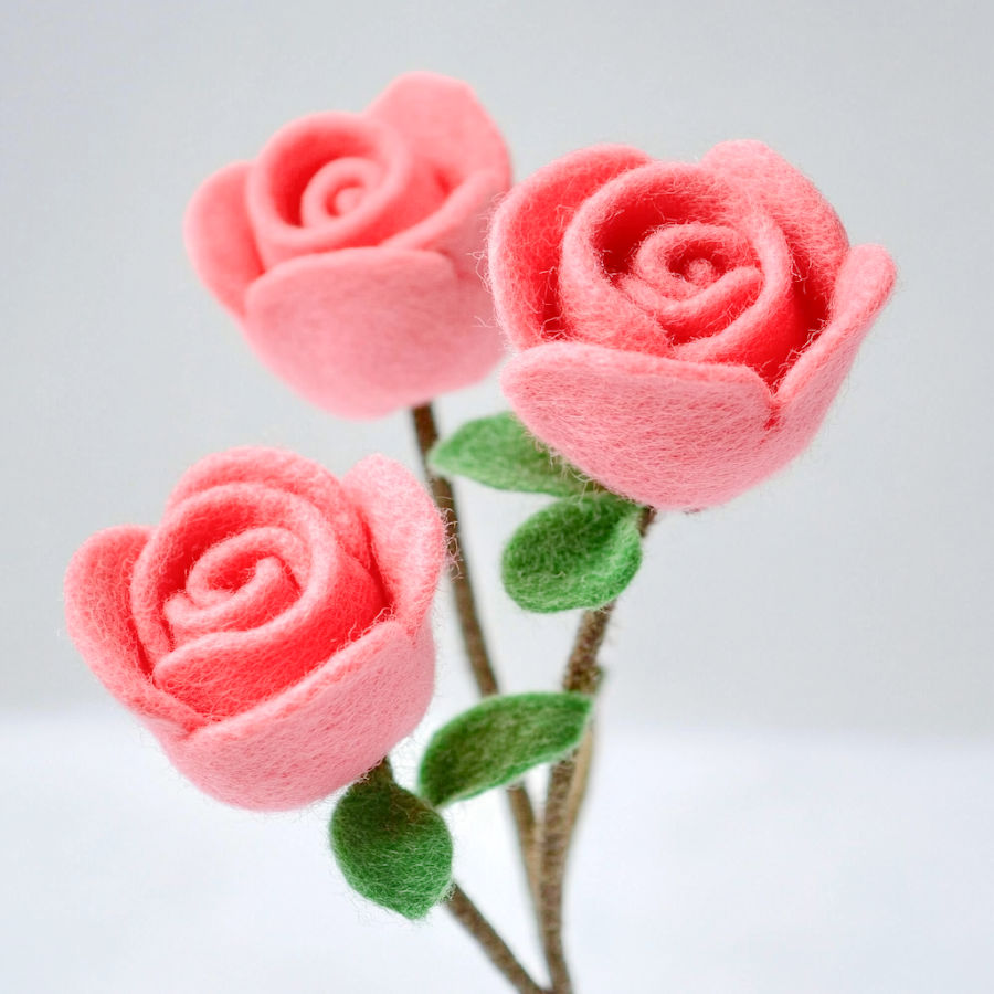 pink roses with green stems and leaves made out of felt fabric