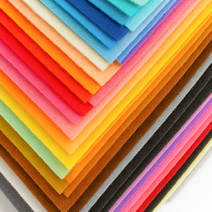 a stack of synthetic felt squares of various colors