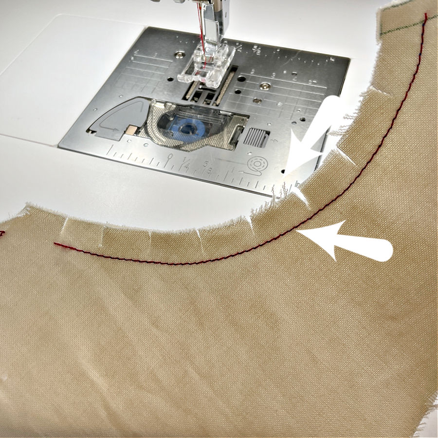 a piece of garment with a curved line showing clippings inn the seam allowance at regular intervals