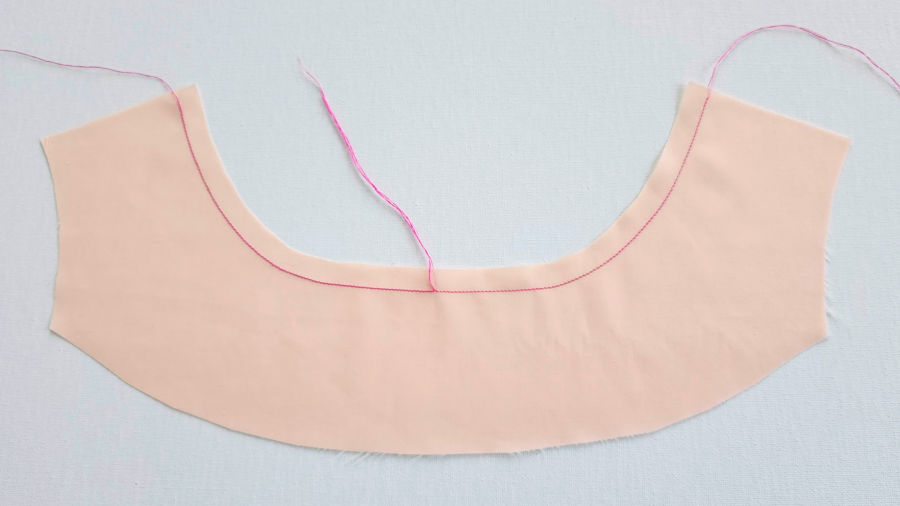 staystitching example on a piece of fabric that has a curved edge similar with a neckline