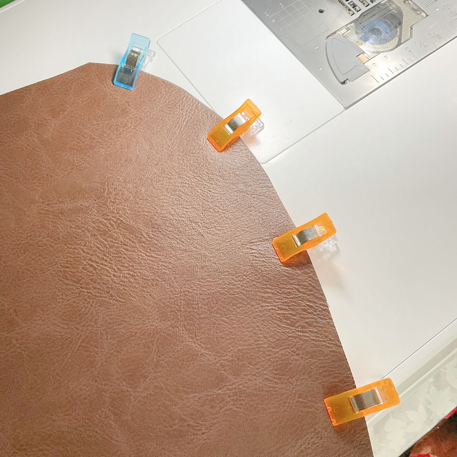 fabric clips in use instead of pins for holding a piece of vinyl