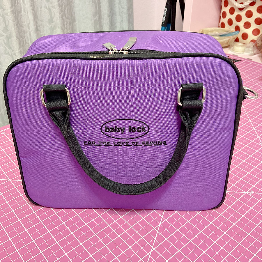 a purple colored storage case which came with the babylock triumph serger overlock