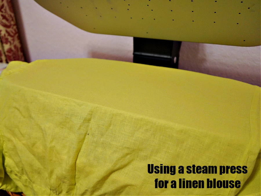 image of a steam press while pressing a linen blouse