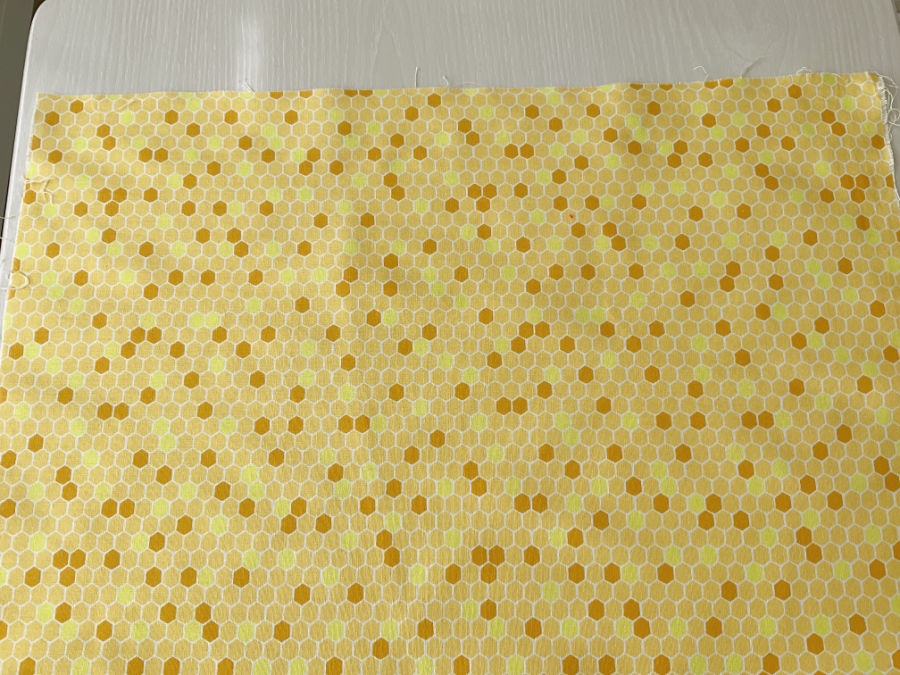 the new unused piece of fabric shown wrinkled in a previous image after pressing