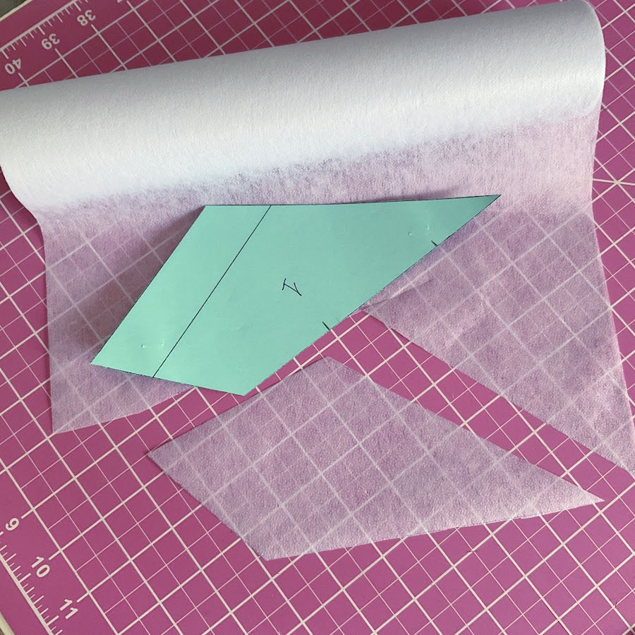 pattern piece number one on a roll of lightweight interfacing after cutting a piece in the shape of the pattern