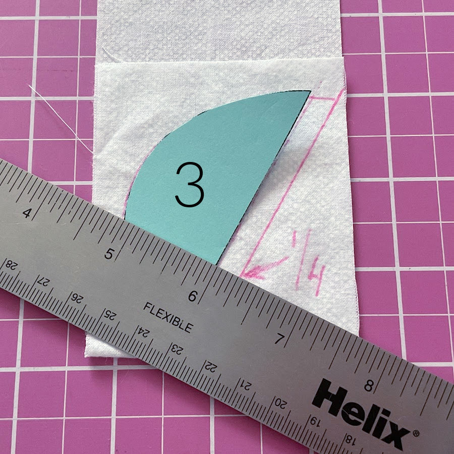 drawing the angels wing on the piece of fabric using the pattern piece number 3