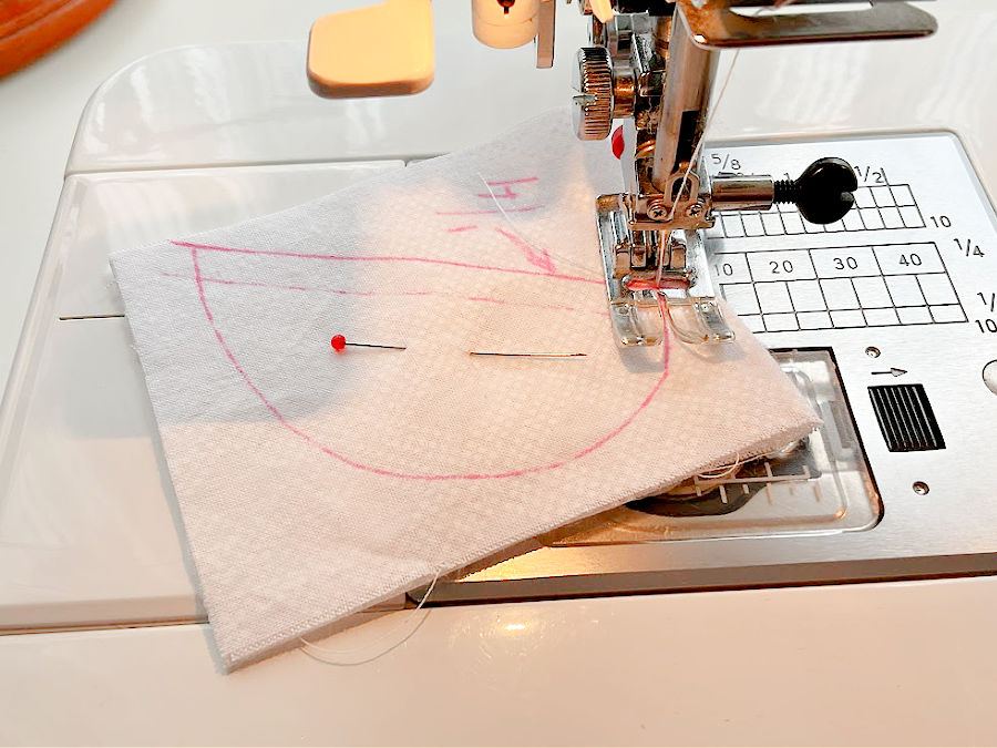 a sewing machine needle assembly shown in the start position for sewing the fabric angels wing