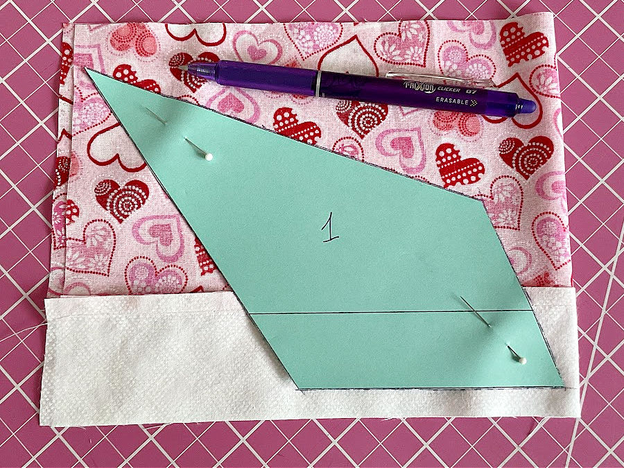 a frixion pen, markings around the template for the angel body on the fabric strip prepared before
