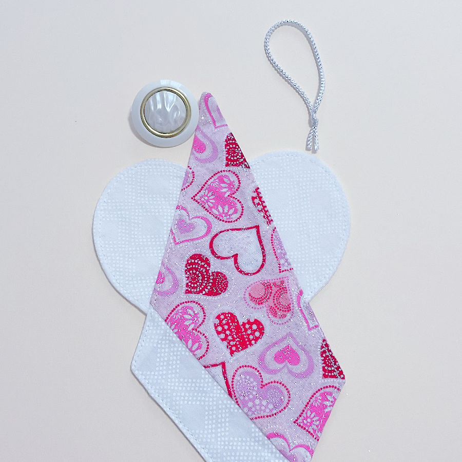 the fabric angel before attaching the final button and the hanging loop